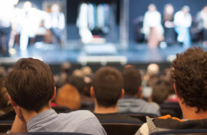 View of the back of an audience at a theatre