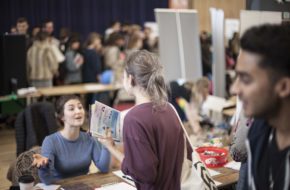 A woman talking to a stall holder at a Freshers' Fair