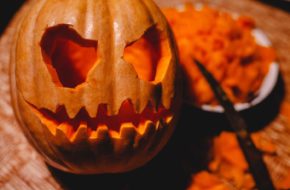 A carved pumpkin with a candle inside